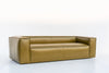 Green leather sofa with wide square arms and stitched panels, three-quarter view