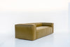 Side view of the Verde leather sofa showing the wide arm and vertical stitched leather panels