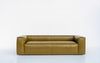 Verde leather sofa with a single bench seat cushion and welted edges